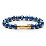 Blue lapis beaded bracelet with gold tube clasp that holds a paper message inside