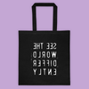 Black cotton tote bag that says SEE THE WORLD DIFFERENTLY backwords