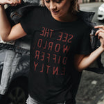 Woman Black T-shirt with reverse red letters that say See The World Differently backwards