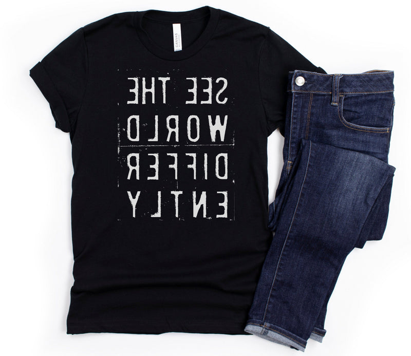 Black T-shirt with reverse white letters that say See The World Differently backwards