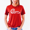 Woman wearing red t-shirt with the word Chingona in white cursive that looks like the Chicago logo