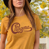 Woman wearing gold t-shirt with Chingona graphic in red cursive that looks like the Chicago logo