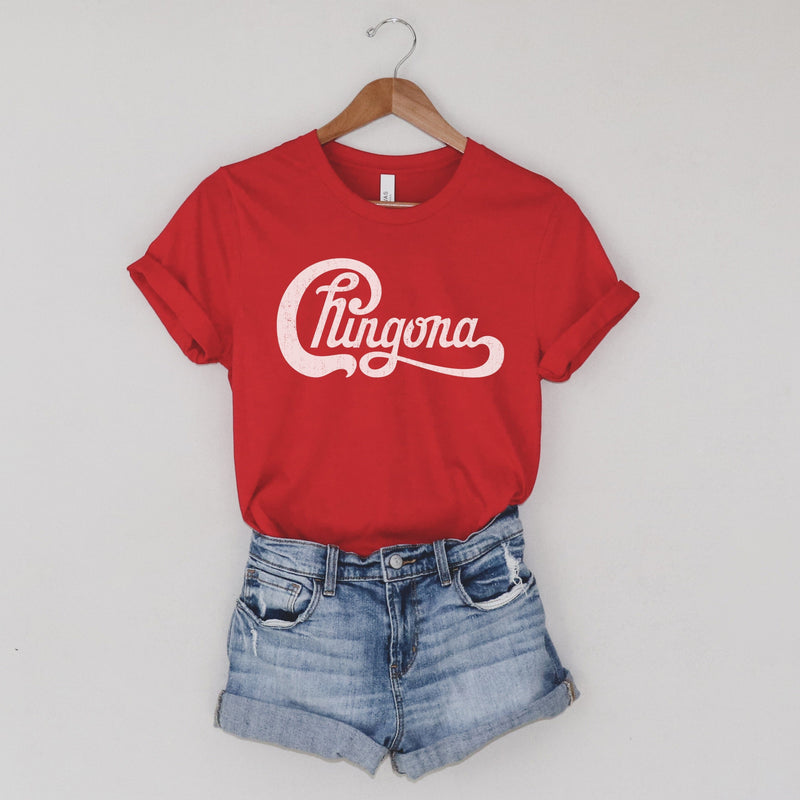 Ladies red t-shirt with Chingona graphic in white cursive that looks like the Chicago logo