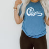 Woman in heather turquoise t-shirt with Chingona graphic in white cursive that looks like the Chicago logo