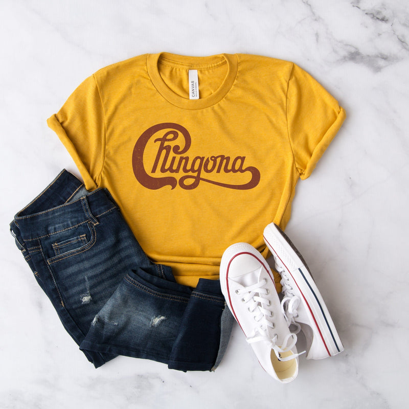 Womebs yellow t-shirt with Chingona graphic in red cursive that looks like the Chicago logo