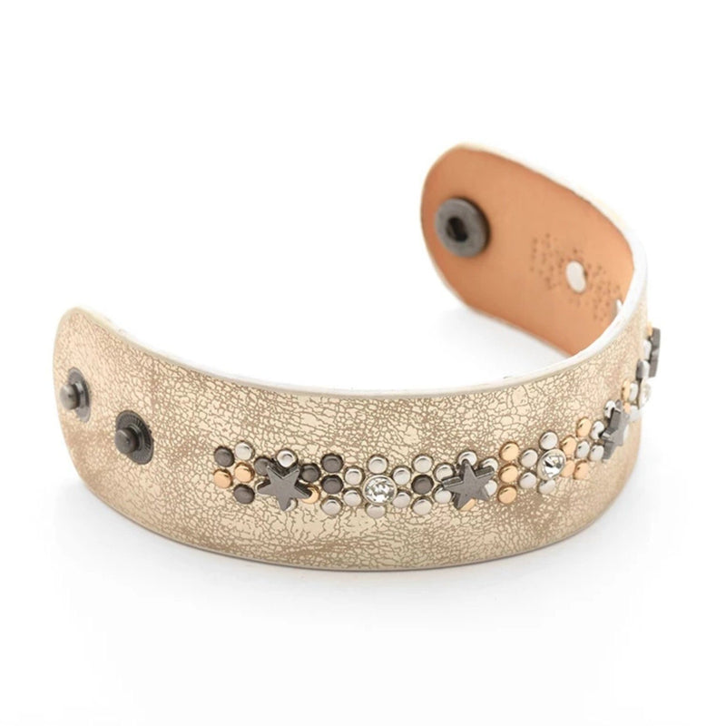 Gold leather cuff bracelet with gold and silver circular studs and metal star accents
