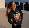black hoodie with rainbow good vibes on pretty woman with ponytail 