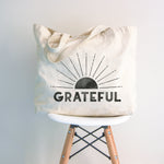 Large canvas tote bag with black distressed sun over the word "GRATEFUL"
