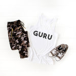 Womens white racerback tank top that says the word 'GURU' on the front in black distressed lettering