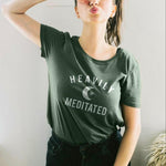 Womens heather forest green t-shirt with white HEAVILY MEDITATED graphic and a white moon in the center