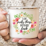 White enamel camp mug with pink flowers and the words I like pretty things and the word fuck