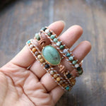 Light brown leather and gemstone beaded wrap bracelet, 3-time wrap, with a green jade faceted gemstone centerpiece