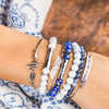 White and blue gemstone bracelet stack that holds written wishes inside