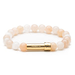 Light pink aventurine gemstone beaded intention bracelet with gold cylinder clasp that unscrews to hold a scroll of paper. Clasp features a handstamped arrow.
