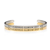 Gold and silver bracelets that say SEE THE WORLD DIFFERENTLY backwards