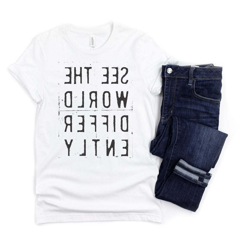 White T-shirt with reverse black letters that say See The World Differently backwards