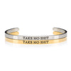 1 silver and 1 gold open cuff bracelet that says TAKE NO SHIT in black lettering