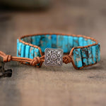 Turquoise stone and brown leather beaded chakra bracelet with silver button closure