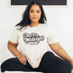 Womens funny New Years Eve Distressed t-shirt in vintage white that says "CHEERS TO MIDNIGHT AND BY MIDNIGHT I MEAN 9PM"