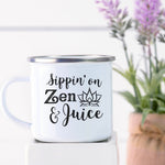 White enamel camp with black Sippin' on zen and juice graphic with lotus flower