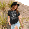 Woman wearing black T-shirt with distressed white Flower Child With A Rock and Roll Soul graphic