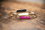 3 Gold and druzy stacking bracelets in pink, white, and black